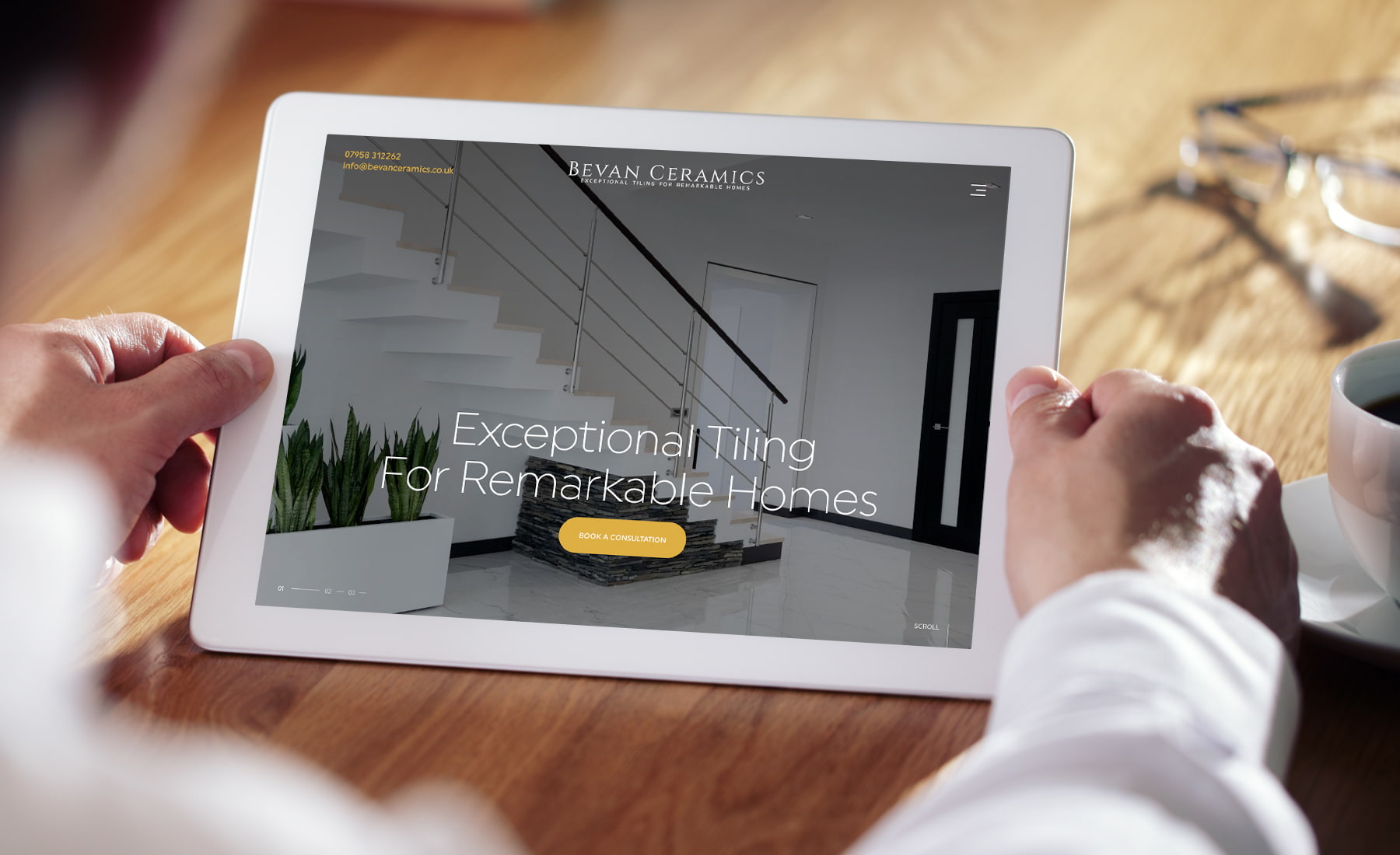 Two hands holding a tablet with opened website