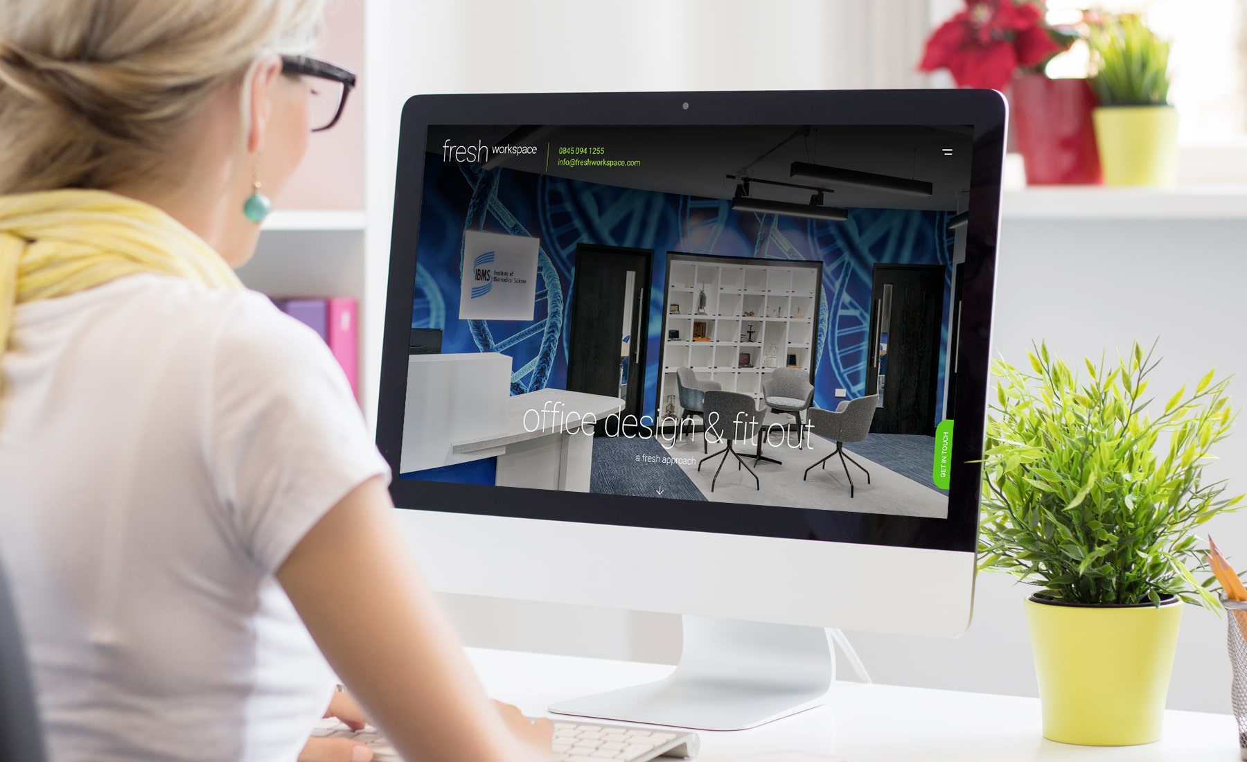 Woman checking website on a white desktop computer